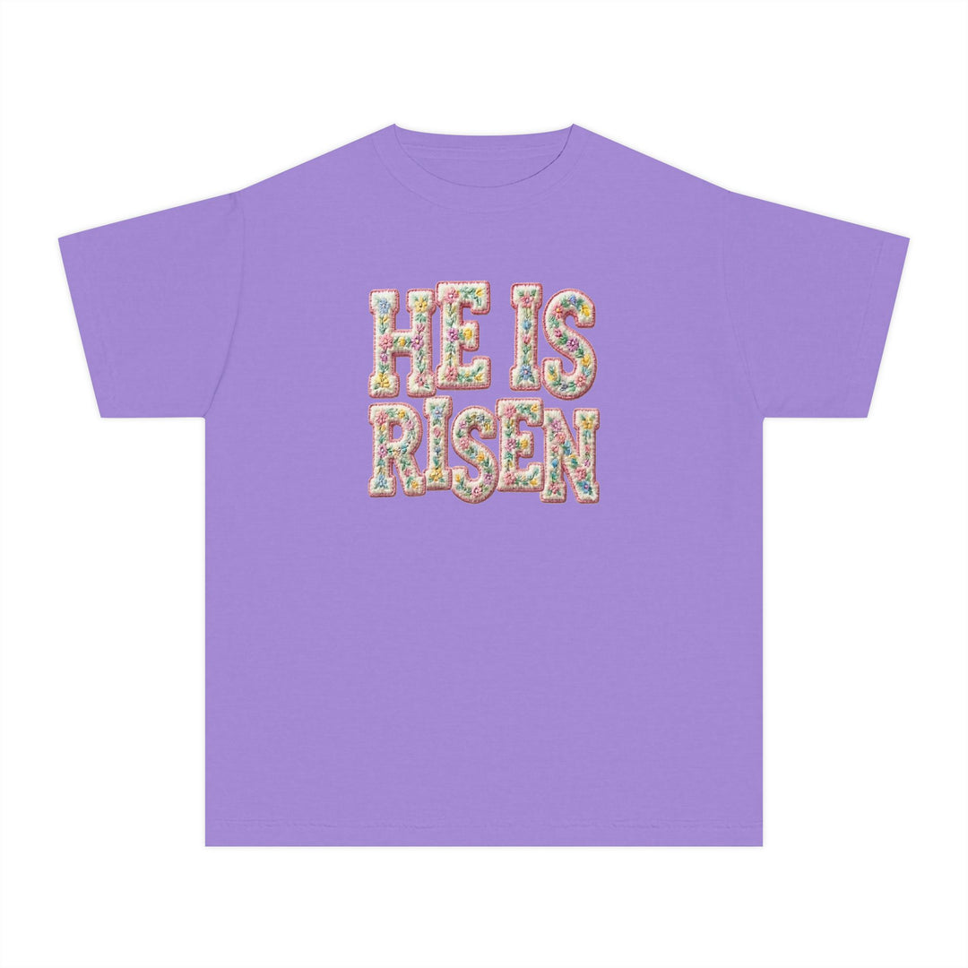 He is Risen Kids Tee with floral embroidered lettering on lavender fabric, crafted for comfort in 100% combed cotton, ideal for active kids.