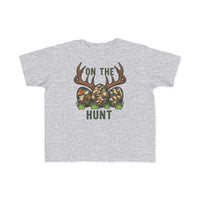 Light-gray toddler tee with 'On the Hunt' graphic of camouflage eggs and deer antlers, perfect for sensitive skin and first adventures.