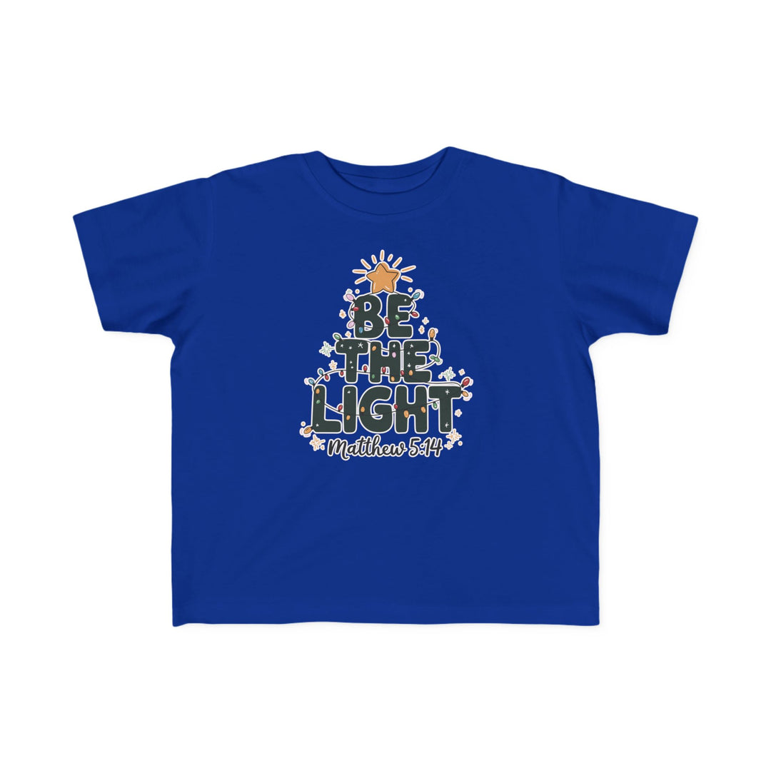 Be the Light Toddler Tee in royal blue with festive BE THE LIGHT design, golden star, string lights, floral accents, and Matthew 5:14 scripture reference.