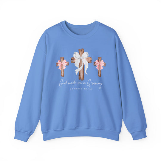 Light-blue sweatshirt with three wooden crosses and 'God made me a Grammy' text, emphasizing comfort and style, from Faith Family Designs.