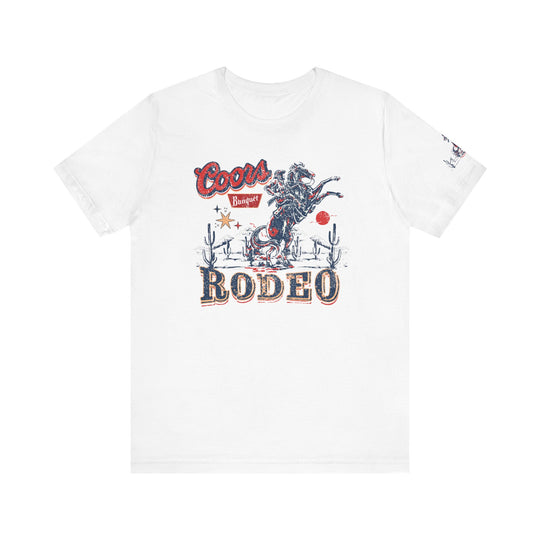 Coors Rodeo Tee: White t-shirt with a graphic design, featuring a logo close-up. Unisex jersey tee with ribbed knit collars, taping on shoulders, and side seams for lasting shape. 100% Airlume combed cotton.