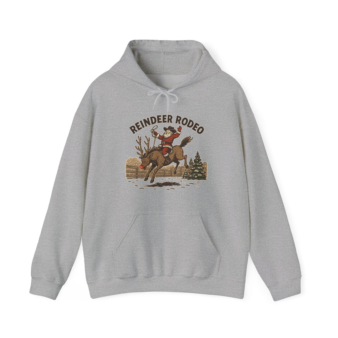 Light-gray Reindeer Rodeo Hoodie featuring Santa as a cowboy riding a reindeer, offering warmth and style with a kangaroo pocket and color-matched drawstrings.