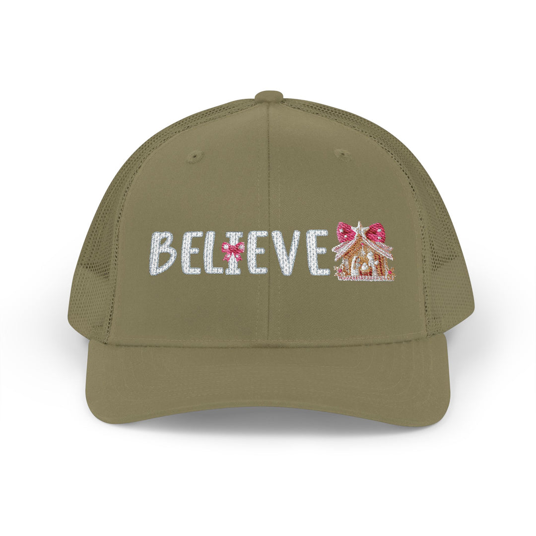 Believe Snapback Trucker Cap (Embroidery) features BELIEVE with a candy-cane I and gingerbread motif, olive-green front, mesh back, and adjustable snap closure.