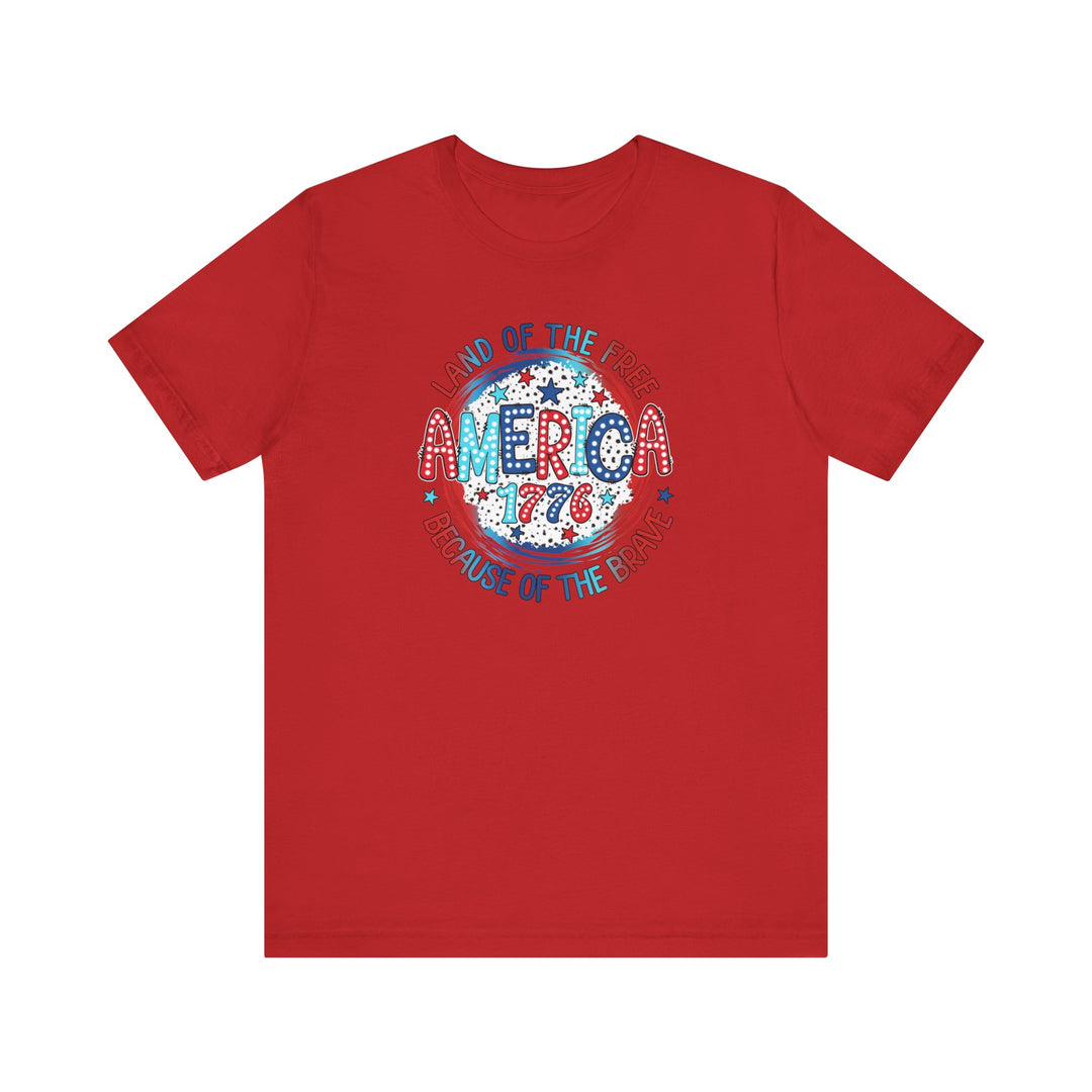 A red America 1776 Tee with a patriotic logo on soft cotton fabric. Unisex fit with ribbed knit collar, taping on shoulders, and tear-away label. Sizes XS to 3XL.