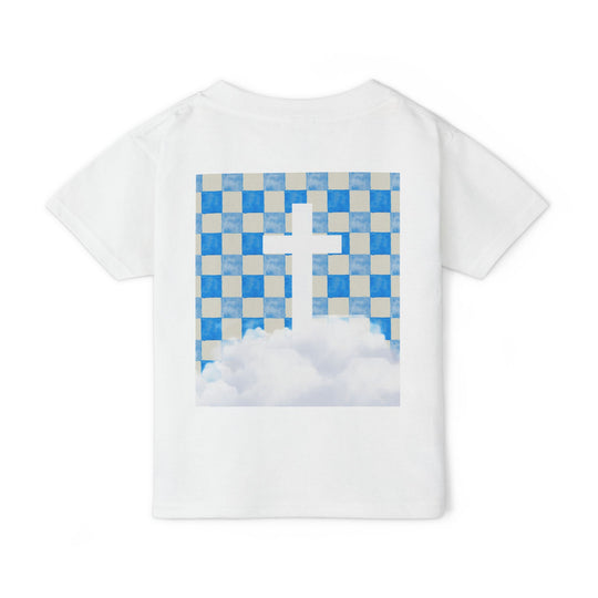 Heavy Cotton™ Toddler T-shirt featuring a blue-and-tan checkerboard graphic with a white cross and clouds on the back, laid flat on a white background.