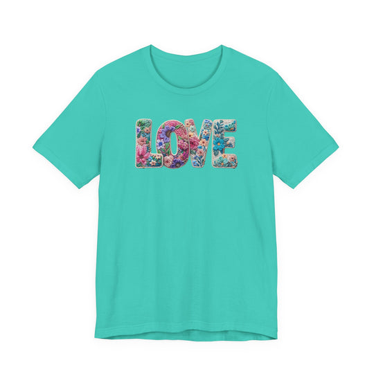 Love Spring Tee featuring LOVE with multicolored floral pattern on bright teal, short-sleeve, cotton shirt, unisex fit, reflecting Faith Family Designs' unique style.