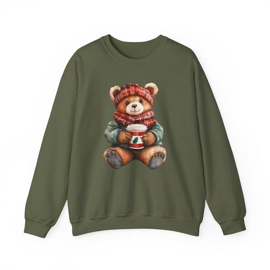 Olive-green sweatshirt featuring a watercolor teddy bear in winter attire, holding a holiday coffee cup. Perfect blend of comfort and style for colder months.