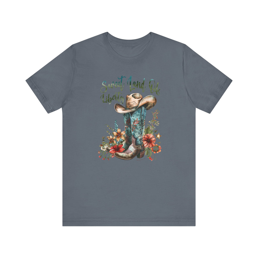 A Sweet Land of Liberty Tee featuring a cowboy hat and boots design on a soft, 100% cotton jersey shirt. Unisex fit with ribbed knit collar, taping on shoulders, and tear away label.
