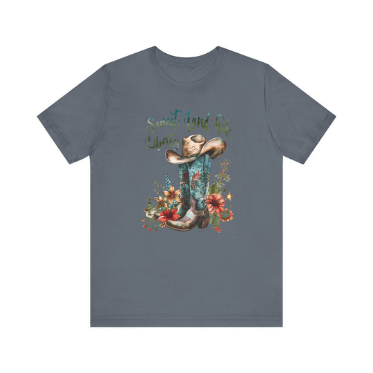 A Sweet Land of Liberty Tee featuring a cowboy hat and boots design on a soft, 100% cotton jersey shirt. Unisex fit with ribbed knit collar, taping on shoulders, and tear away label.
