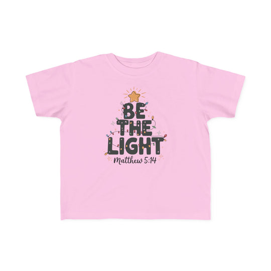 Be the Light Toddler Tee with festive tree graphic, 'BE THE LIGHT' text, and Bible verse Matthew 5:14. Soft, durable, perfect for toddlers' sensitive skin.