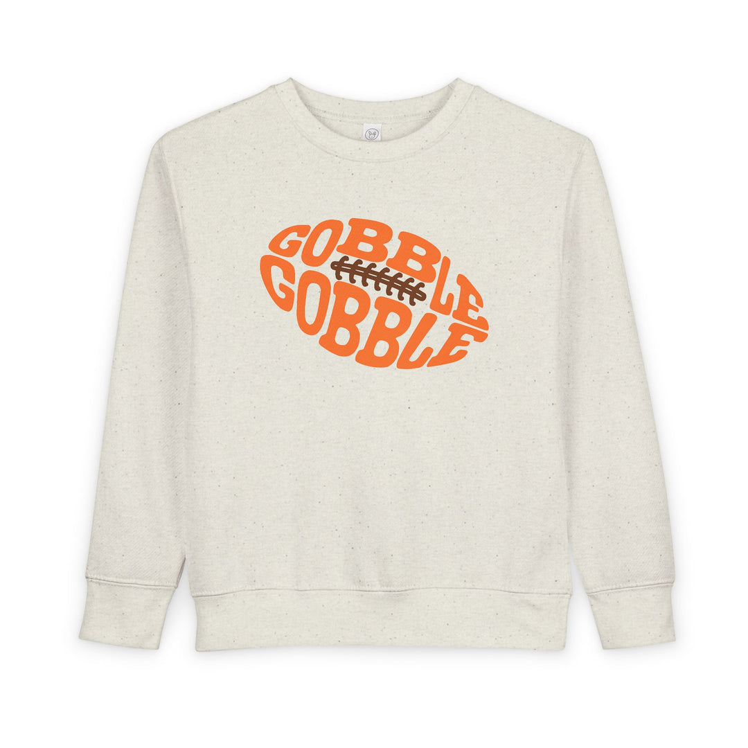 Gobble Football Toddler Crew sweatshirt featuring a Thanksgiving-themed orange football graphic with GOBBLE GOBBLE text, crafted for comfort and durability.