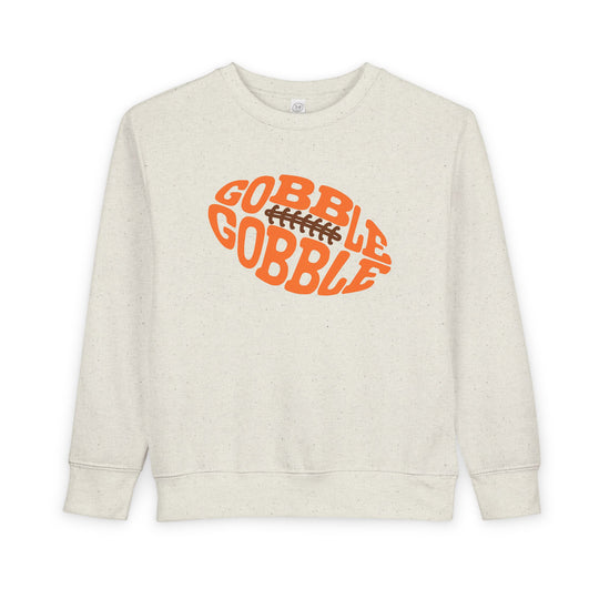 Gobble Football Toddler Crew sweatshirt featuring a Thanksgiving-themed orange football graphic with GOBBLE GOBBLE text, crafted for comfort and durability.