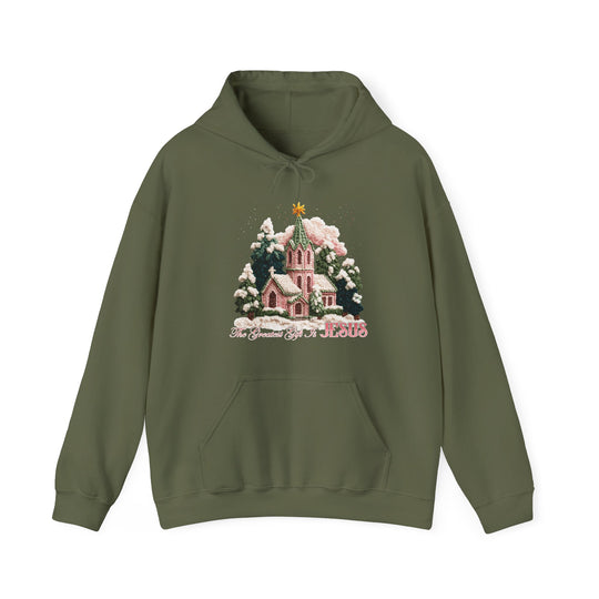 Olive-green Gift is Jesus hoodie featuring a snow-dusted church print among pine trees, with a star above and inspirational text below, offering warmth and style.