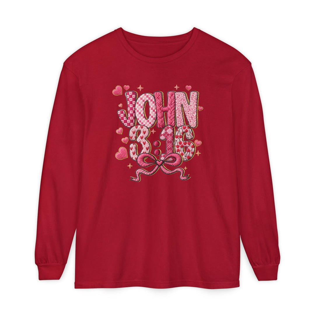 Red long-sleeved 3:16 Long Sleeve Tee featuring patchwork-style JOHN 3:16 graphic with heart patterns and a pink ribbon bow, offering a casual, comfortable fit.