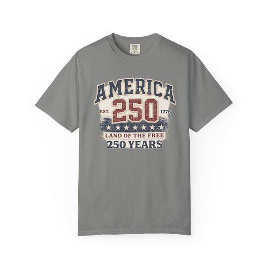 Gray America 250 Years tee with vintage patriotic design, featuring block letters and stars, by Comfort Colors. Ideal for a relaxed, durable wardrobe staple.