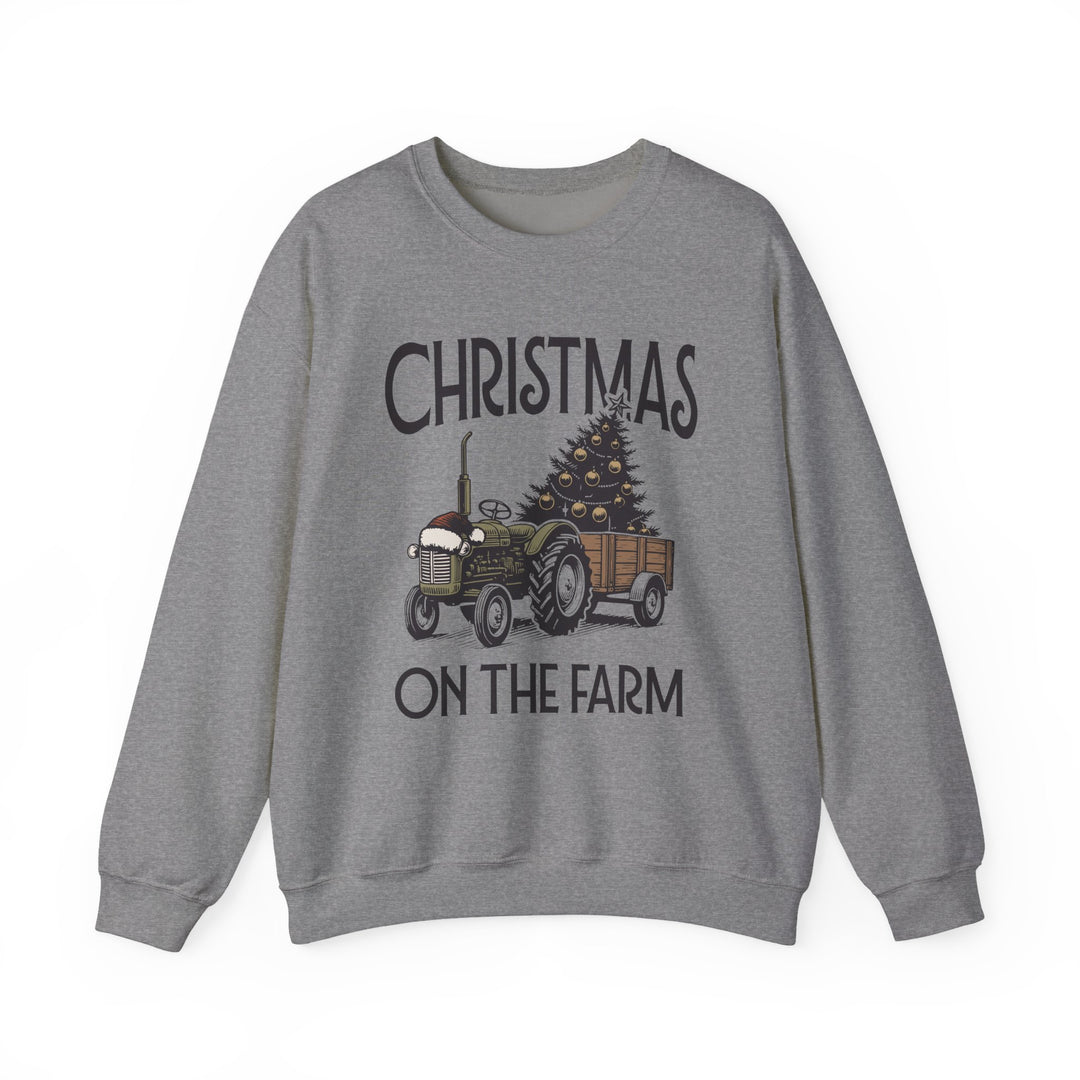 Gray crewneck sweatshirt featuring 'CHRISTMAS ON THE FARM' with a vintage tractor and Christmas tree, embodying comfort and festive charm.