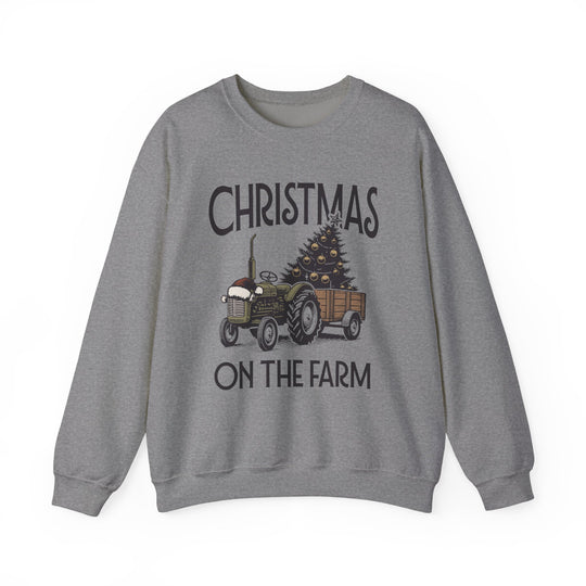 Gray crewneck sweatshirt featuring 'CHRISTMAS ON THE FARM' with a vintage tractor and Christmas tree, embodying comfort and festive charm.