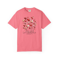 Love Never Fails Tee with hand-drawn heart balloons and 1 Corinthians 13:8 text, perfect for expressing faith and style.