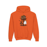 Ghost Hunter Youth Hoodie features a Halloween graphic of a ghost, bats, hunting tower, skulls, and pumpkins on an orange hooded sweatshirt with a kangaroo pocket.