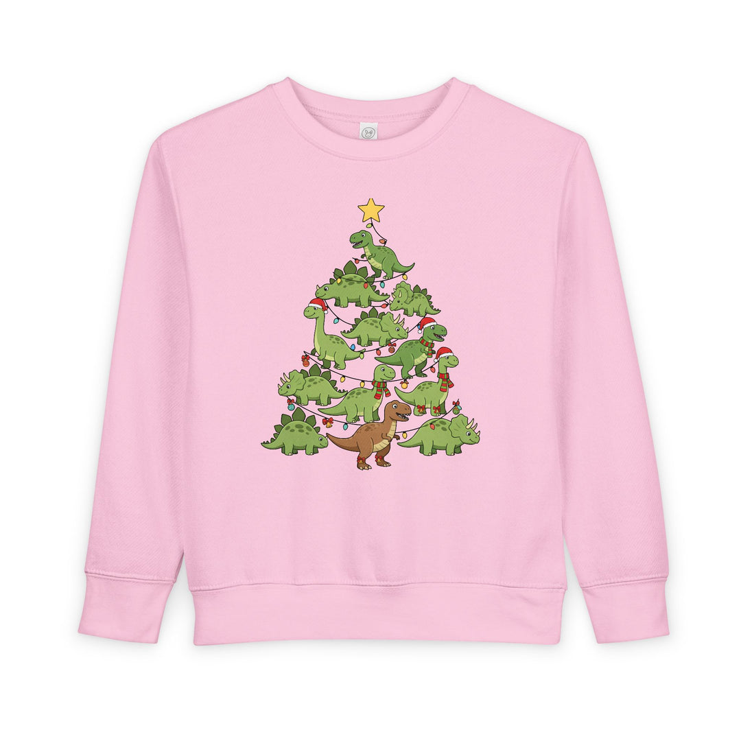 Light-pink toddler crewneck sweatshirt featuring a festive dino tree graphic with cartoon dinosaurs in holiday attire, providing warmth and style.