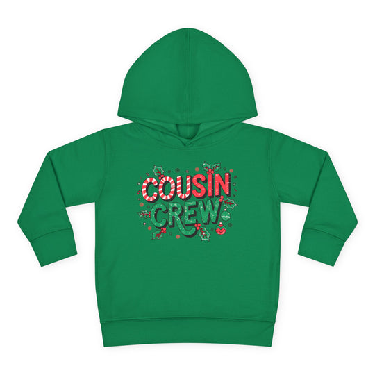 Cousin Crew Christmas Toddler Hoodie with festive design, featuring COUSIN CREW text, holly, snowflakes, and ornaments. Cozy, durable hoodie with jersey-lined hood and side seam pockets.