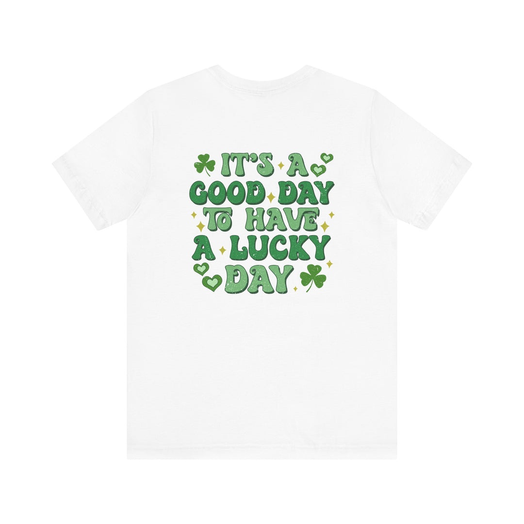 Good Day Lucky Day Tee: A classic white t-shirt featuring green text with hearts and clovers, crafted from soft cotton for a comfortable, unisex fit.