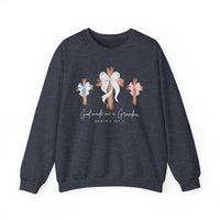 Dark-heather navy crewneck with three wooden crosses and bows, featuring God Made Me a Grandma text. Comfortable unisex fit, ideal for casual wear.