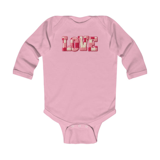 Baby's Love Onesie: Soft pink long-sleeve bodysuit with LOVE in chenille letters, featuring durable snap closures for easy diaper changes. Ideal for comfort and style.