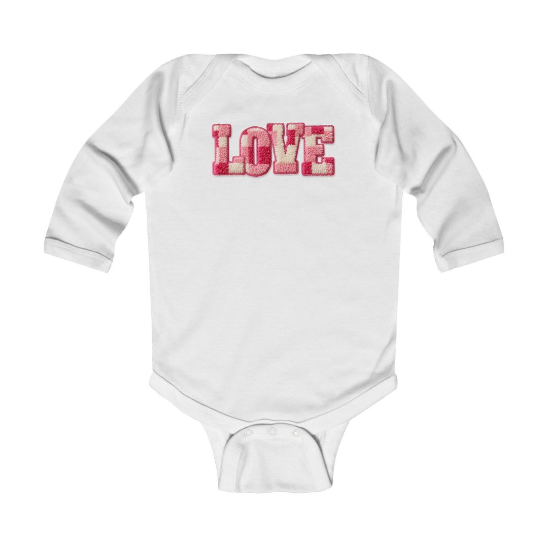 Love Onesie: White infant bodysuit with LOVE in textured pink and red letters, featuring long sleeves and snap closures for easy changing. Smooth, durable cotton fabric.
