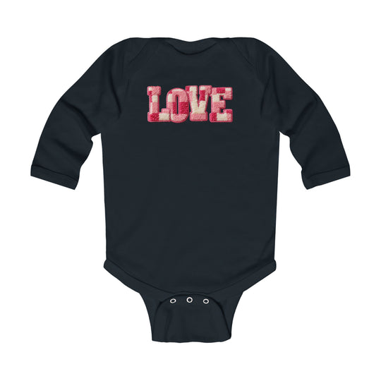 Love Onesie: Navy infant bodysuit with LOVE patch in pink and off-white, long sleeves, and snap closures for easy diaper changes. Soft, durable cotton fabric.