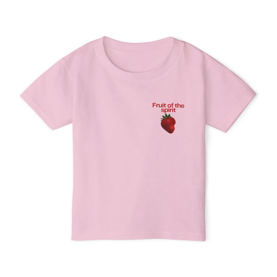 Fruit of the Spirit Toddler Tee features a light pink, short-sleeved design with a red text graphic and strawberry illustration on the chest.