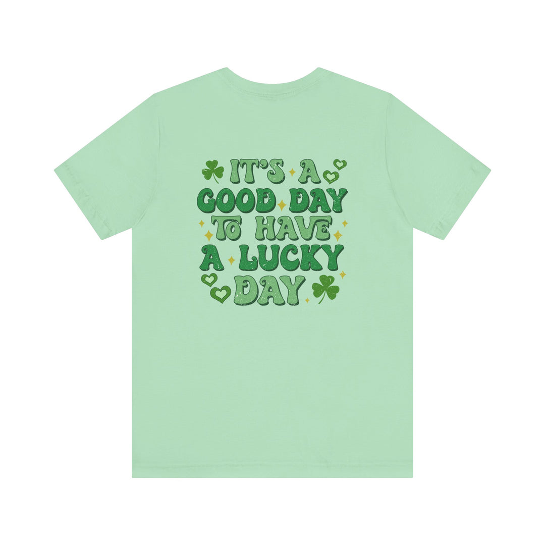 Good Day Lucky Day Tee featuring a green clover with gold stars, offering a classic unisex fit in soft cotton for enduring comfort and style.