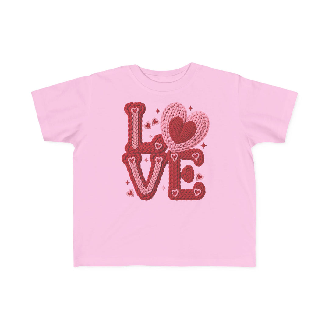Light-pink “Love Heart Toddler Tee” with chunky yarn-style “LOVE” graphic and overlapping heart motifs, designed for toddler comfort and durability.
