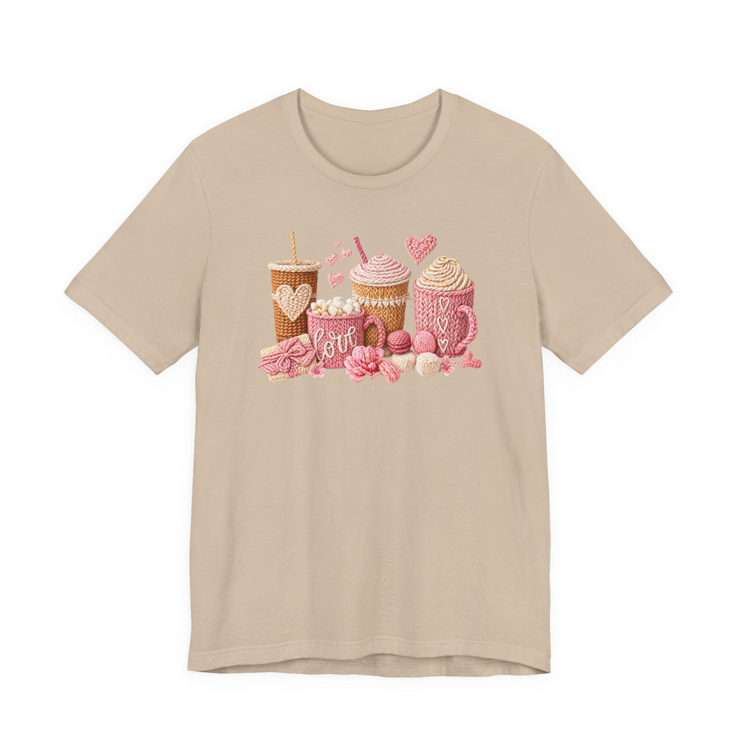 Coffee Love Tee featuring whimsical, yarn-style graphics of warm drinks and treats, crafted on a light-beige T-shirt, embodying cozy charm and quality craftsmanship.