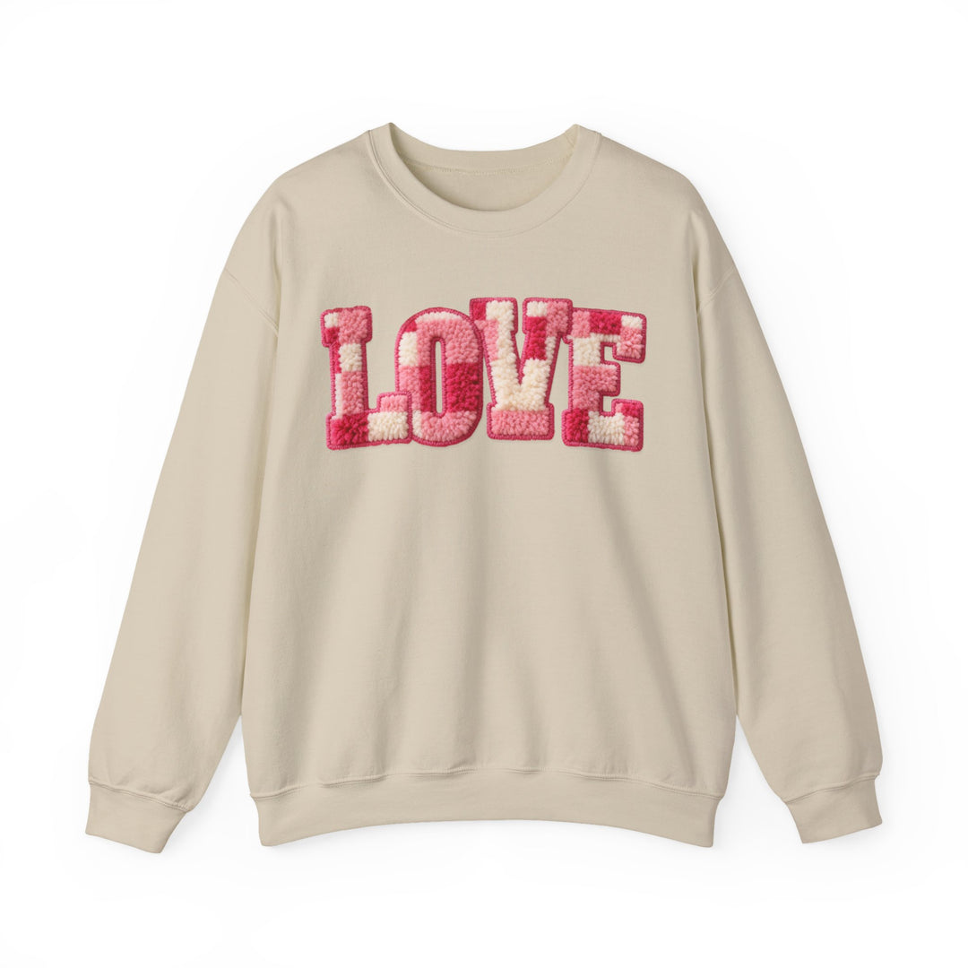 Love Crew sweatshirt with 'LOVE' in pink and white chenille appliqué on chest; cream-colored, long-sleeve, ribbed collar, polyester-cotton blend for comfort.