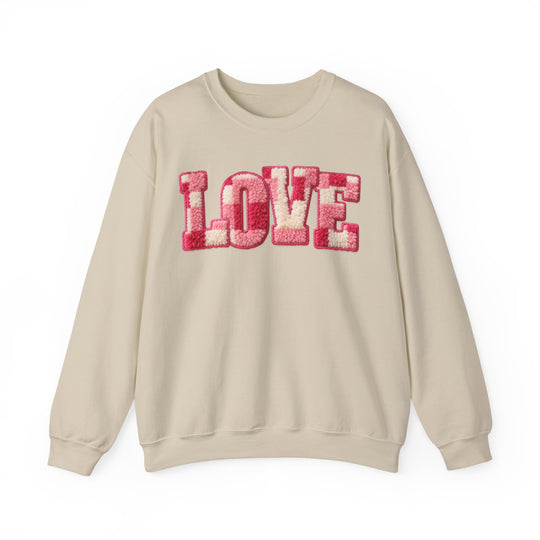 Love Crew sweatshirt with 'LOVE' in pink and white chenille appliqué on chest; cream-colored, long-sleeve, ribbed collar, polyester-cotton blend for comfort.