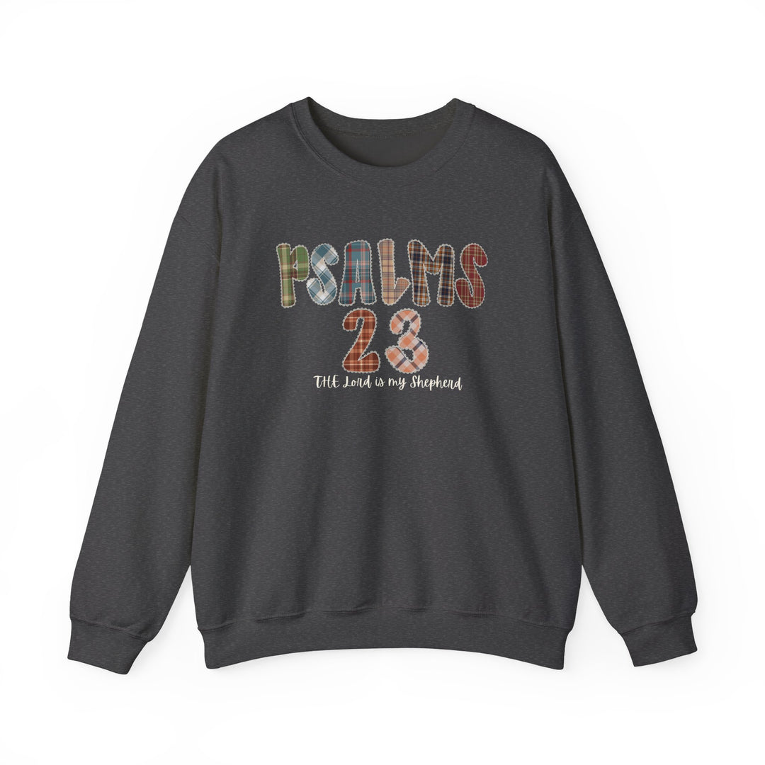 Dark charcoal-gray crewneck sweatshirt featuring PSALMS 23 in multicolored plaid letters, with cursive text below reading The Lord is my shepherd.