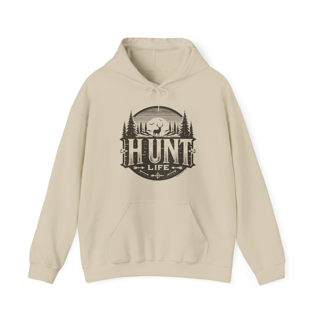 A beige Hunt Life Hoodie with a deer and tree logo on a cotton-polyester blend. Features kangaroo pocket, drawstring hood, and tear-away label. Medium-heavy fabric for comfort and warmth.