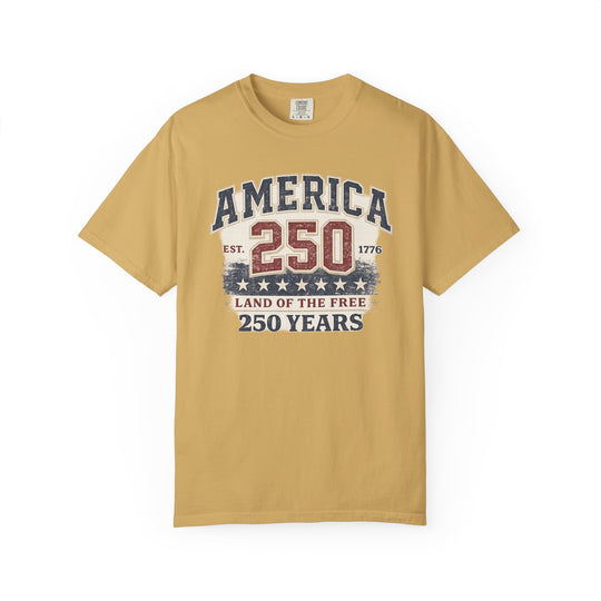 Mustard-yellow “America 250 Years Tee” featuring distressed patriotic graphics in red, white, and blue with stars, printed on a Comfort Colors cotton T-shirt, size L.