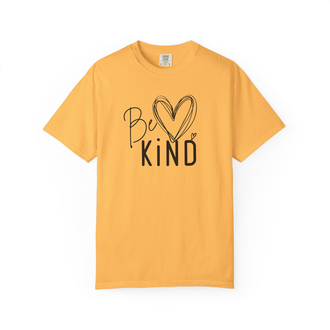 Be Kind Tee features a golden-yellow short-sleeve shirt with Be ♥ KiND in a stylish black font, offering a relaxed fit and soft fabric.