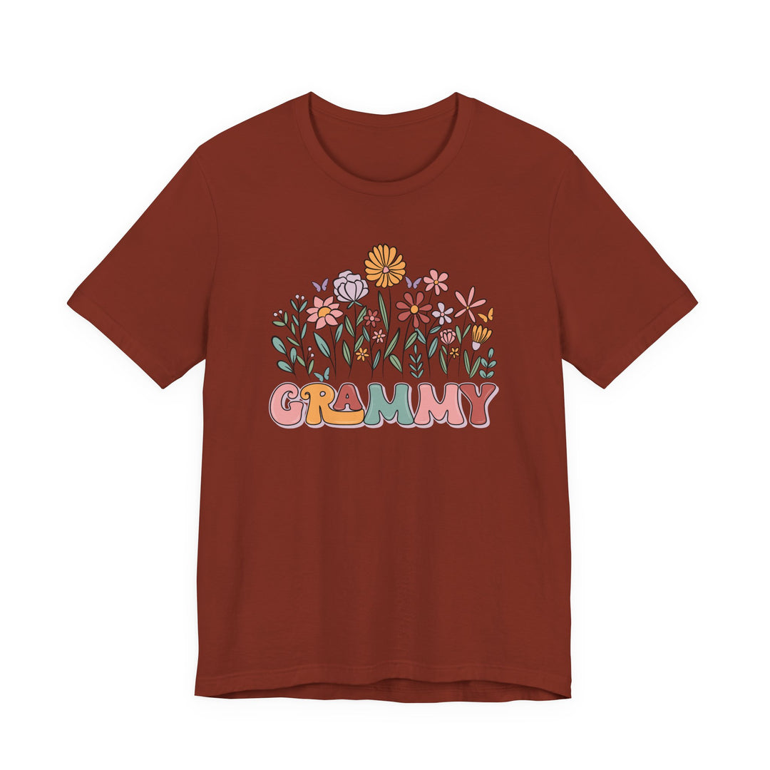 Rust-colored Grammy Flower Tee with pastel floral design and colorful GRAMMY text, short-sleeve, soft cotton, unisex fit, by Faith Family Designs.