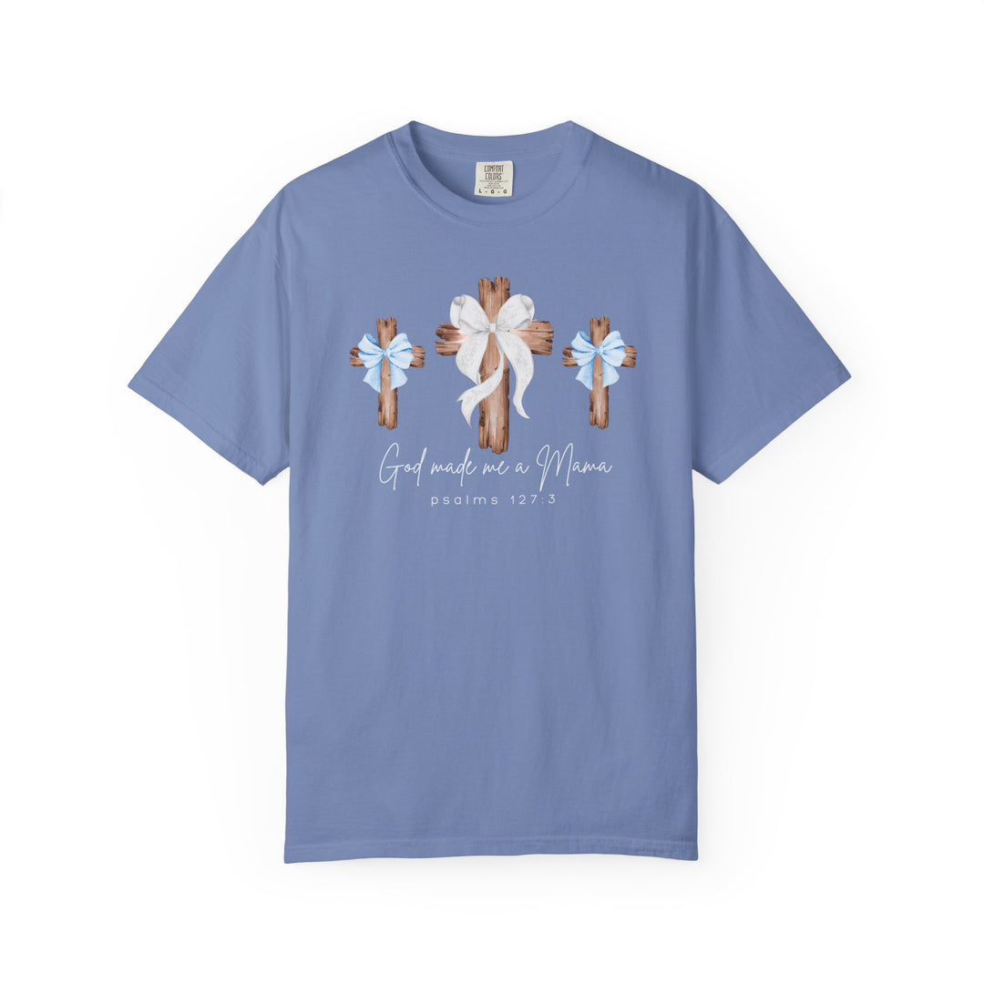 Light periwinkle-blue unisex tee with rustic wooden crosses and 'God Made Me a Mama' script, crafted by Comfort Colors for Faith Family Designs.