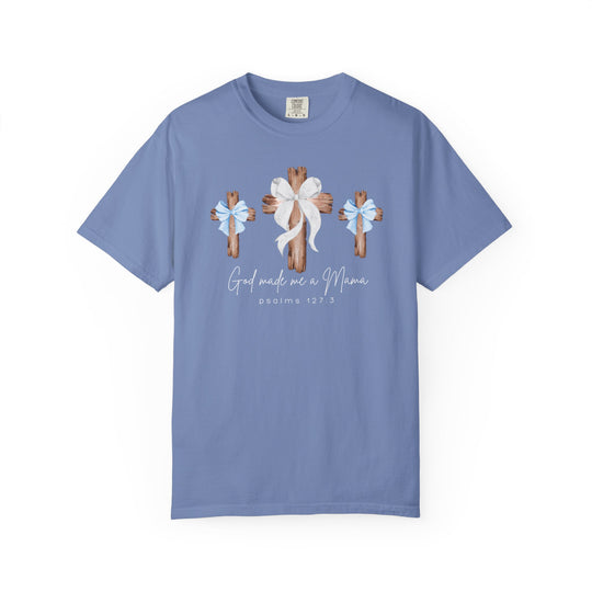 Light periwinkle-blue unisex tee with rustic wooden crosses and 'God Made Me a Mama' script, crafted by Comfort Colors for Faith Family Designs.