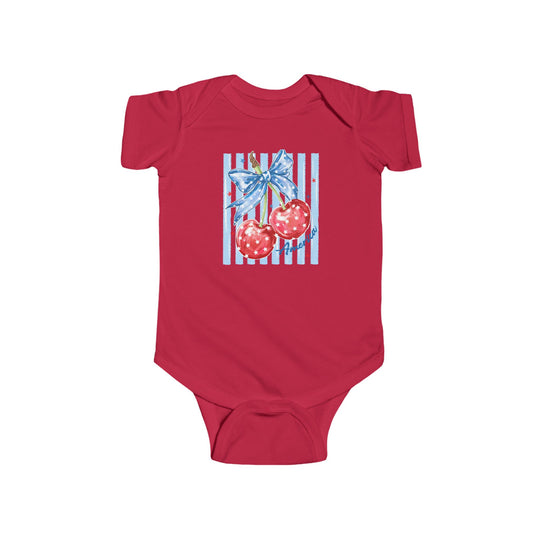 American Cherry Onesie: Red baby onesie with patriotic cherry graphic, featuring white stars and a blue bow, on a light blue, star-studded striped background.