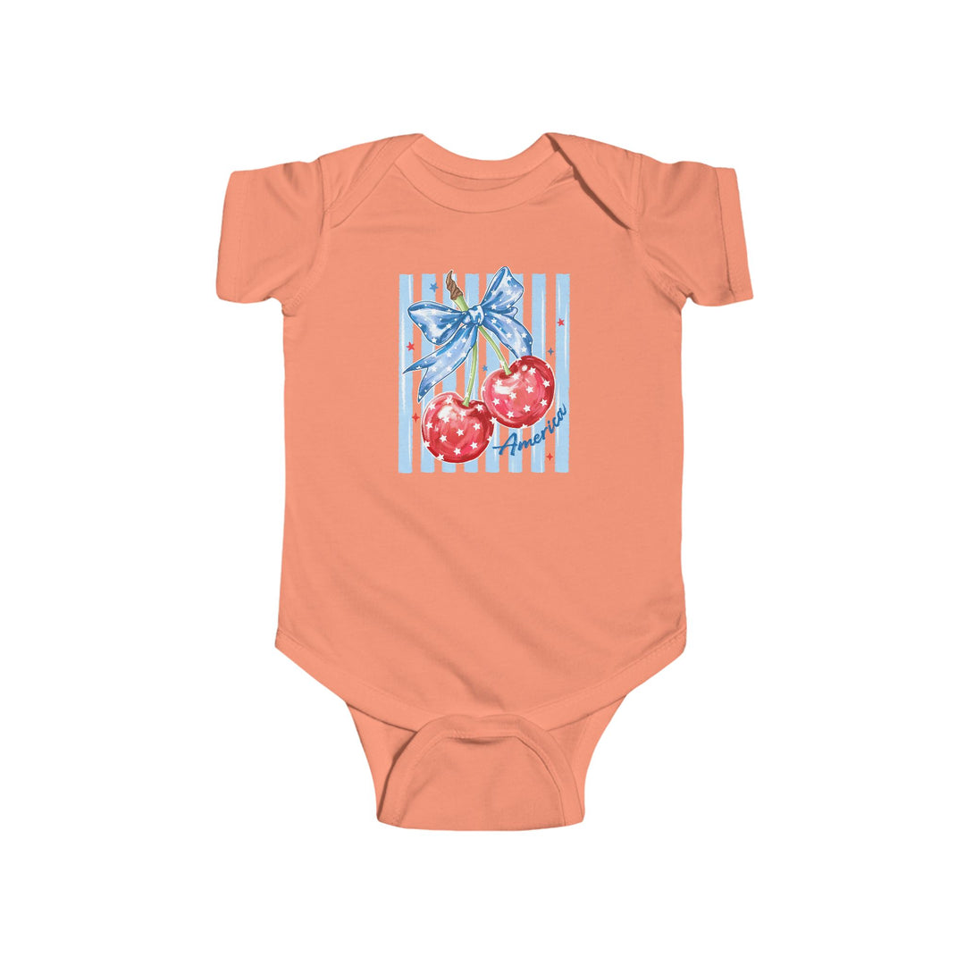 American Cherry Onesie: Soft coral baby bodysuit featuring cherries with a blue star ribbon and America script, ensuring comfort with durable cotton and convenient snap closures.