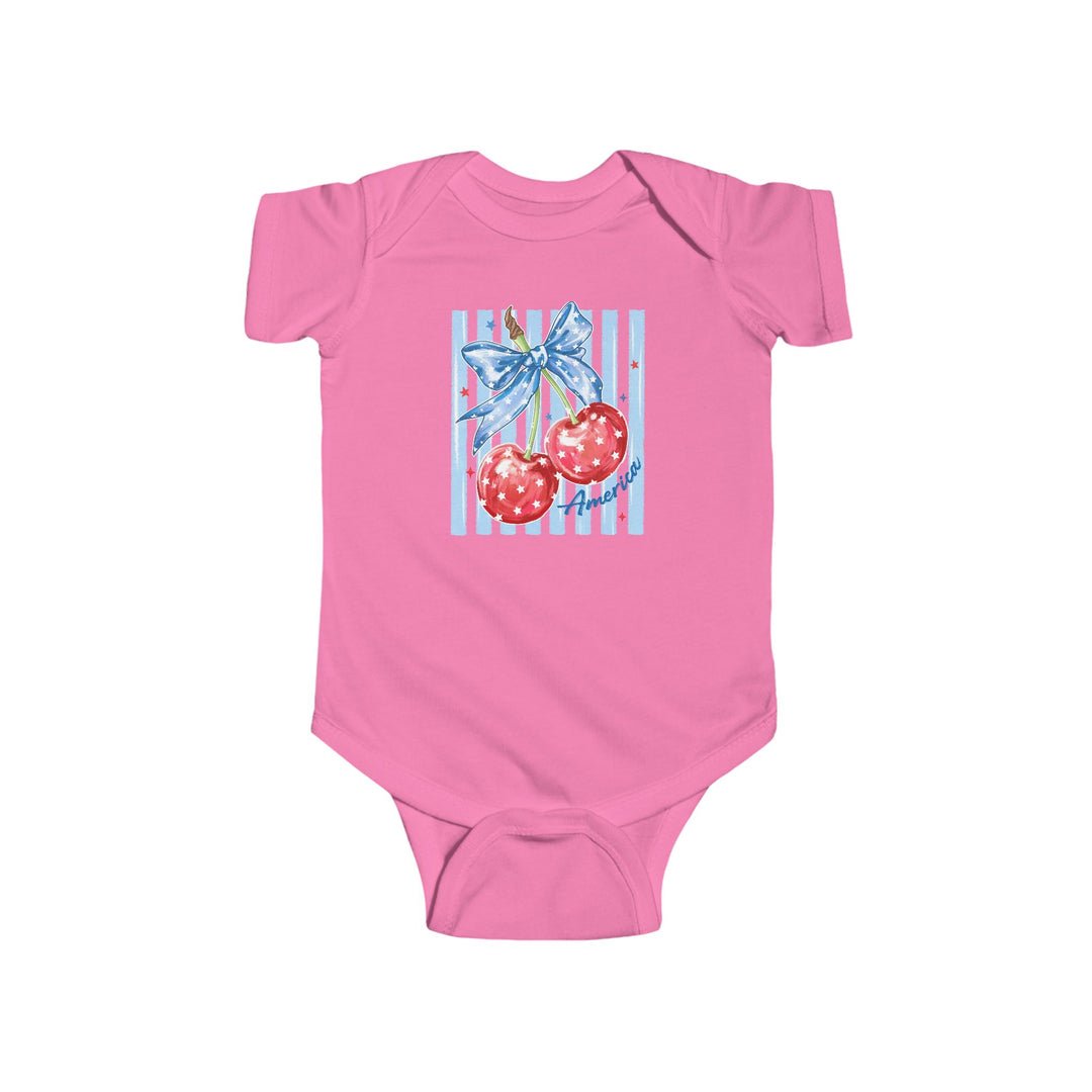 American Cherry Onesie: Pink infant bodysuit featuring glossy cherries with a blue ribbon, pale blue stripes, and America in cursive. Durable cotton, easy-snap closure.