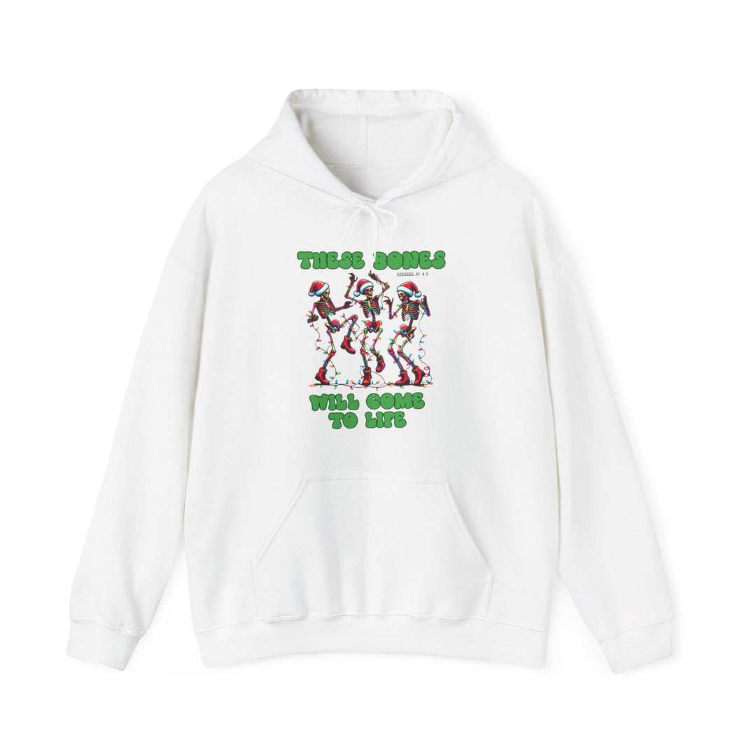 White hoodie with dancing skeletons in Christmas lights, Santa hats, and green text saying “THESE BONES WILL COME TO LIFE” with “Ezekiel 37:4-5” reference.