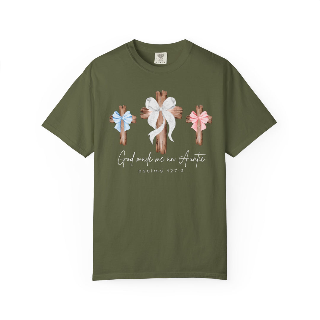 Olive-green tee featuring three wooden crosses with bows and “God made me an Auntie” text, emphasizes faith and family. Comfortable, durable, and ideal for everyday wear.