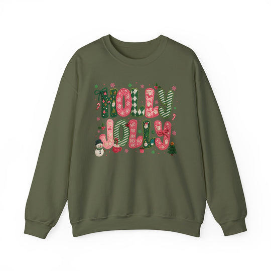 Olive-green crewneck sweatshirt with HOLLY JOLLY in festive, colorful letters and Christmas motifs, including a snowman and miniature tree, by Faith Family Designs.