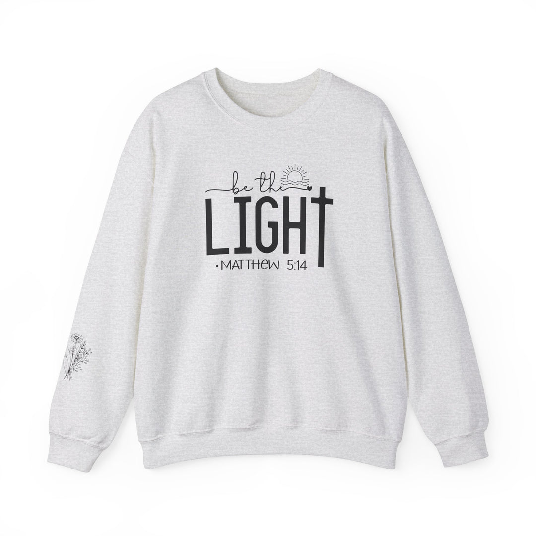 A unisex heavy blend crewneck sweatshirt, the Be the Light Crew, offers comfort with ribbed knit collar and durable double-needle stitching. Made from 50% cotton and 50% polyester, ideal for colder months. Ethically grown US cotton.